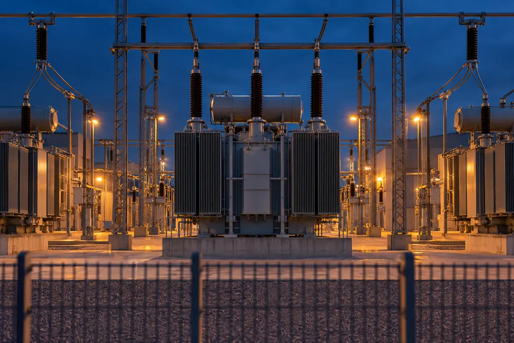 Electrical substation of an industrial plant with power transformers at dusk